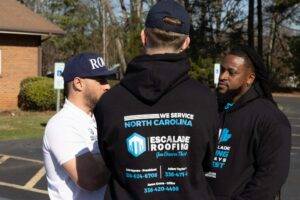 roof maintenance Greensboro escalade roofing workers talking clemmons nc